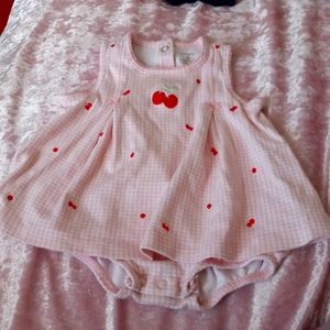 A pink and white checkered dress with cherries